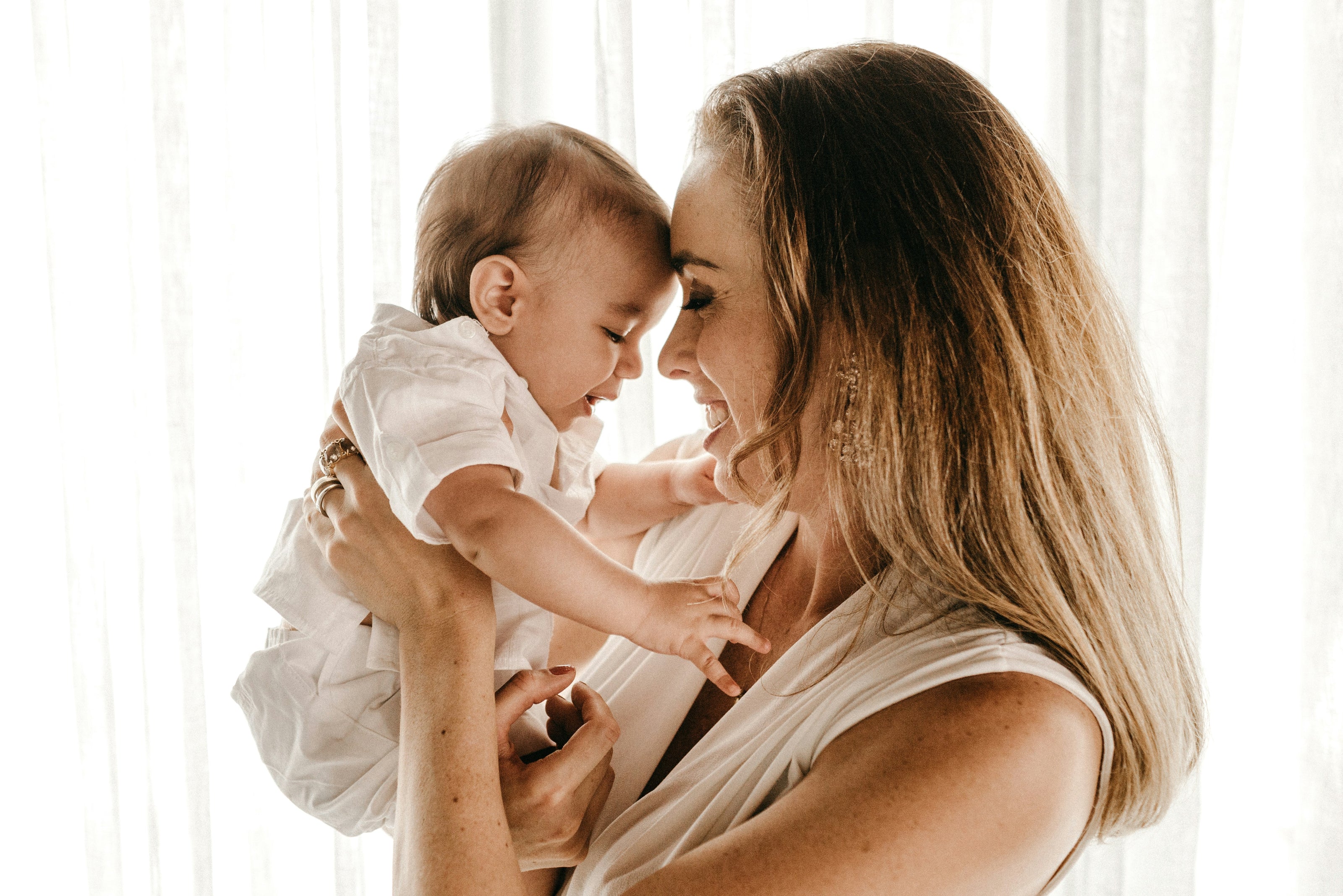 Woman holding a baby in a softly lit room
